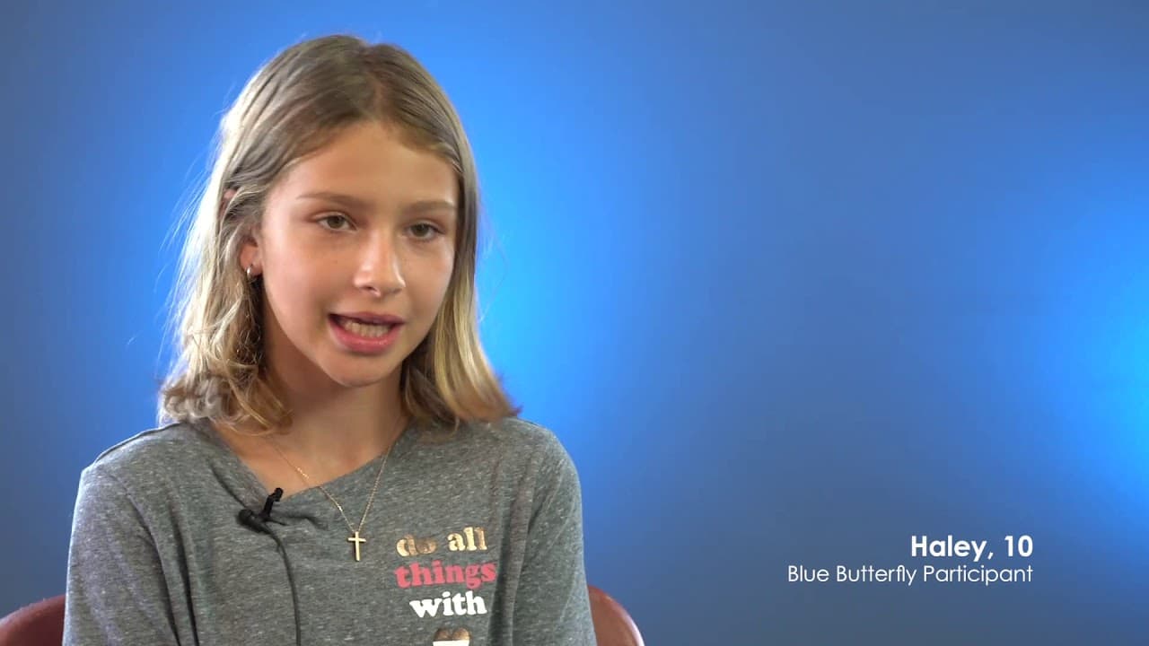 A girl speaking to camera in a Blue Butterfly video, captioned Haley, 10, Blue Butterfly Participant.